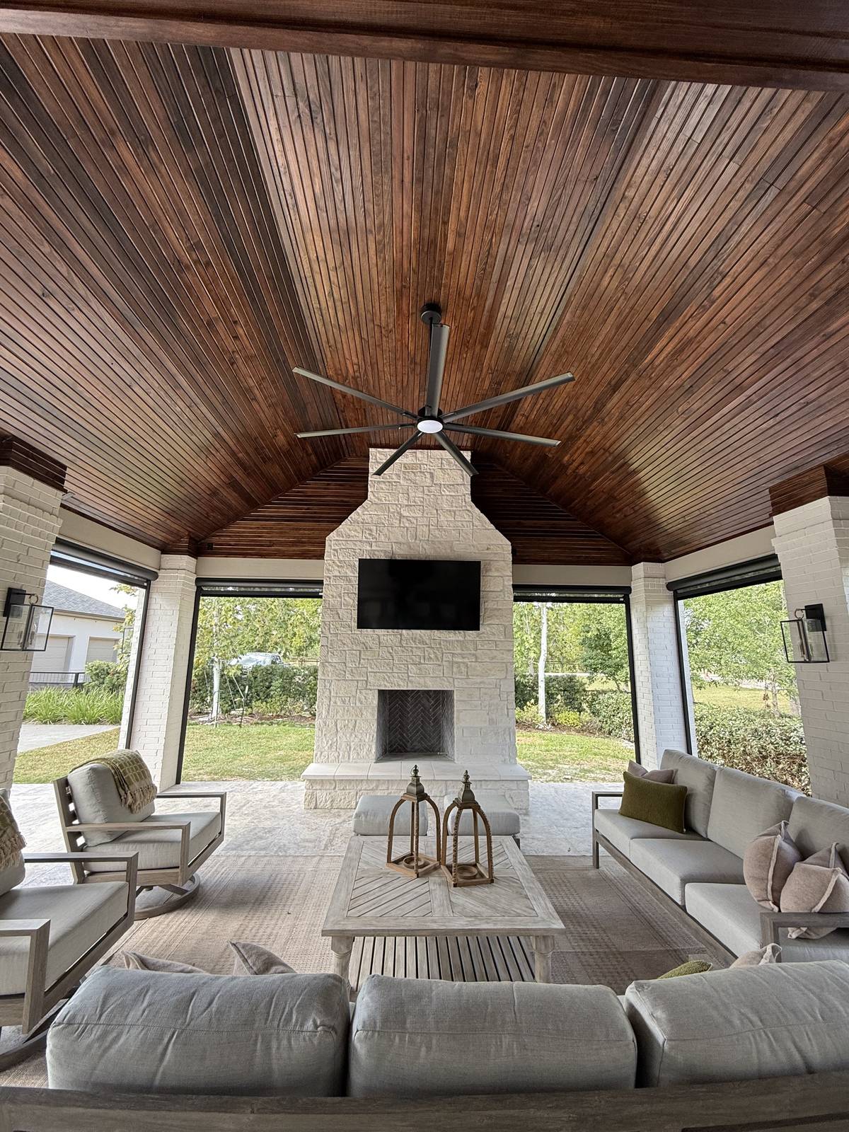 Pavilion with stone fireplace, stained tongue-and-groove ceiling and outdoor seating